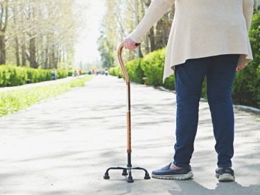 A person with a cane walking